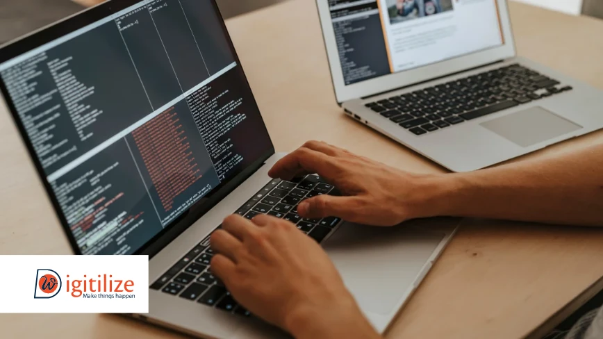 Developer coding on a laptop with DigitilizeWeb branding