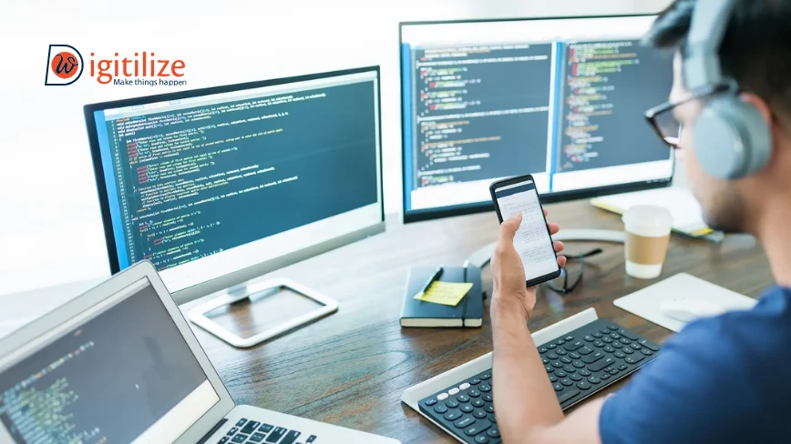 Developer coding on multiple screens | Digitilizeweb