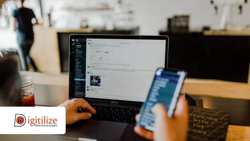 Person using laptop and smartphone in cafe | DigitilizeWeb